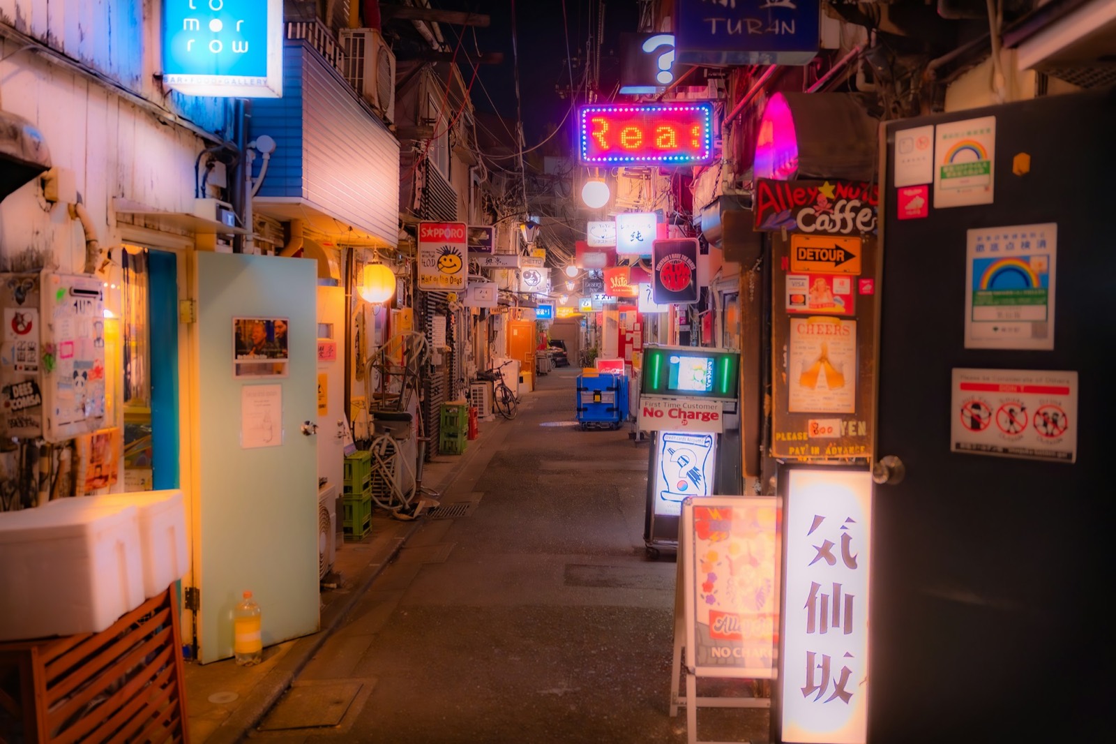 A narrow neon-lit alleyway shimmering at night